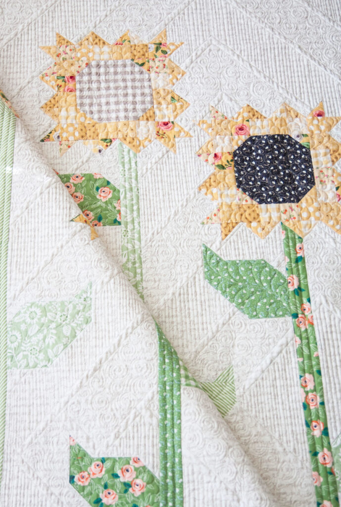Scrappy Sunflowers quilt pattern by Lella Boutique. Fabric is Farmer's Daughter by Lella Boutique for Moda Fabrics