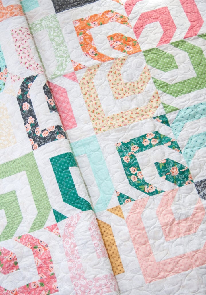 Kaleidoscope jelly roll quilt by Vanessa Goertzen of Lella Boutique. Fabric is Sugar Pie by Lella Boutique for Moda Fabrics. Mesmerizing modern log cabin quilt design.