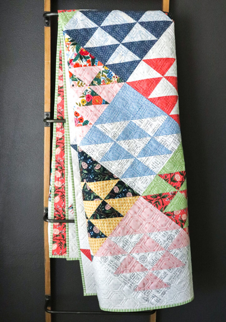 homestead triangle layer cake quilt by Vanessa Goertzen of Lella Boutique. Fabric is Wildwood by Rifle paper Co for Cotton + Steel