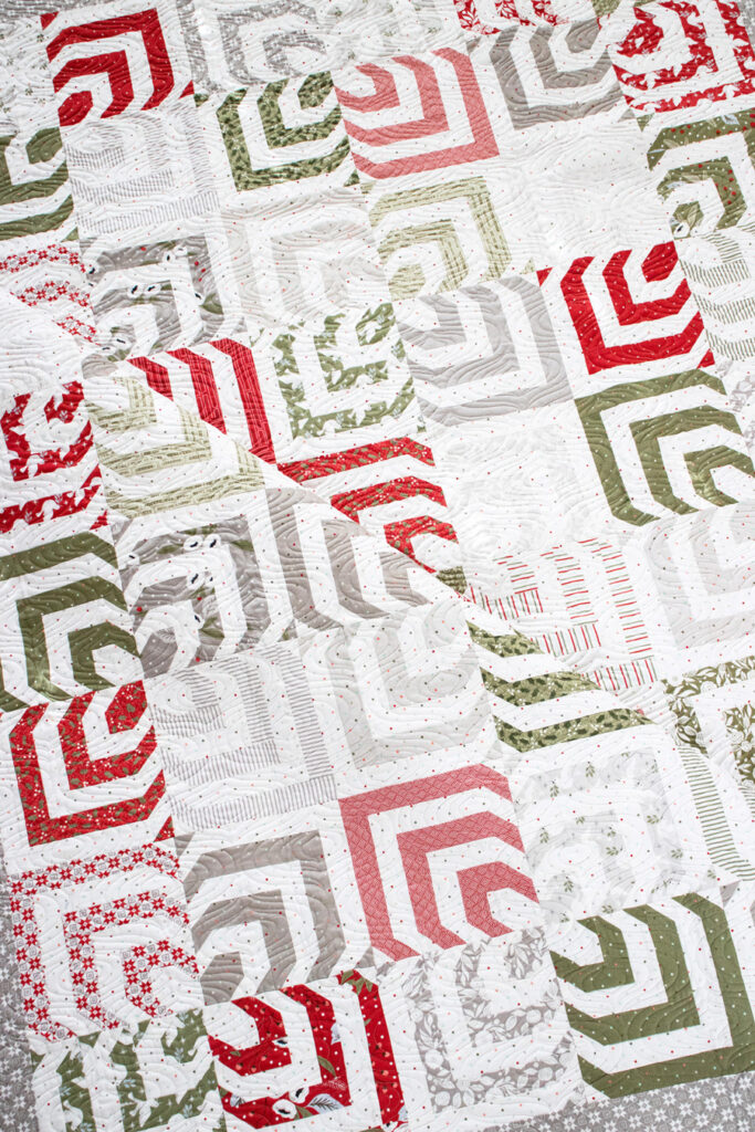 Kaleidoscope honeybun quilt by Lella Boutique. Mesmerizing spin on a log cabin block. Fabric is Christmas Morning by Lella Boutique for Moda Fabrics.