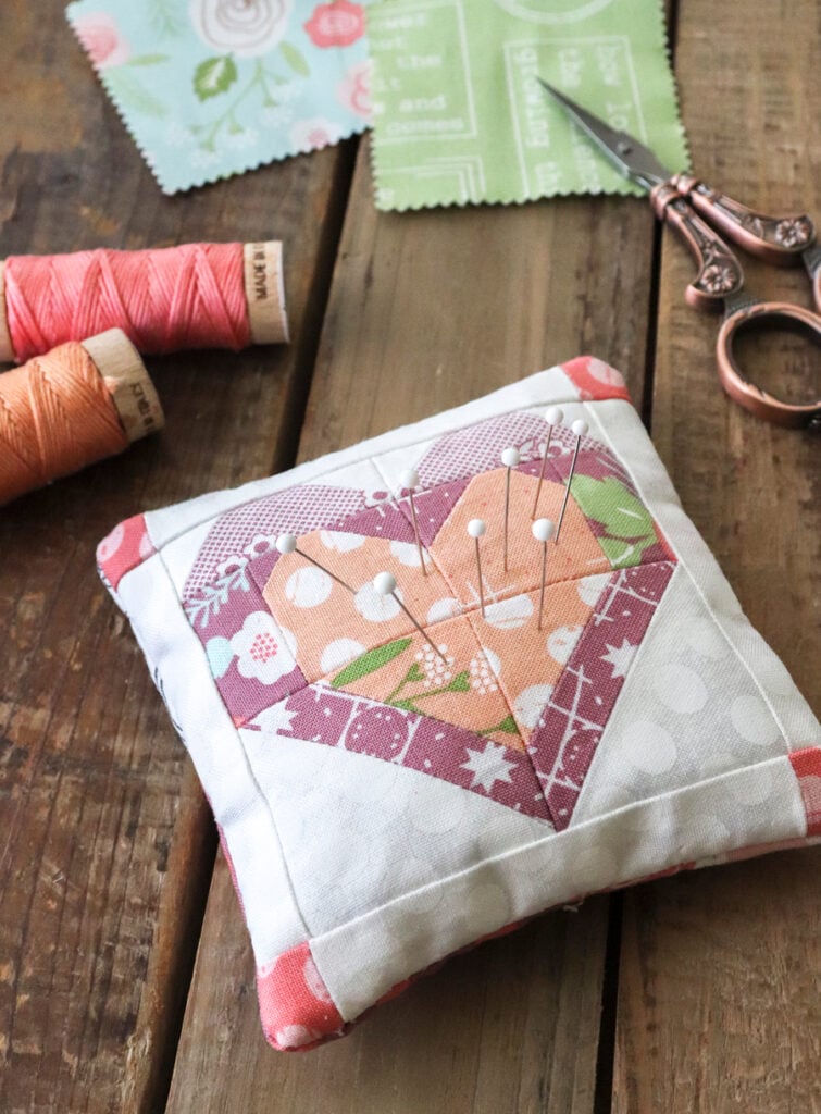 Mini Open Heart pin cushion by Lella Boutique. Makes a great mini charm pack project. Fabric is Lollipop Garden by Lella Boutique for Moda.