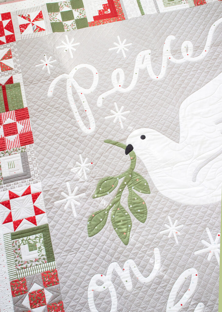 Peace on Earth panel by Lella Boutique. Coordinates with the Christmas Morning fabric collection for Moda Fabrics. Features a faux patchwork border.