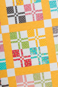 Lickety-Split disappearing 4-to-9 patch quilt pattern by Lella Boutique. Pattern found in the book: Charm School - 18 Quilts from 5" Squares. Fabric is by Corey Yoder for Moda Fabrics.