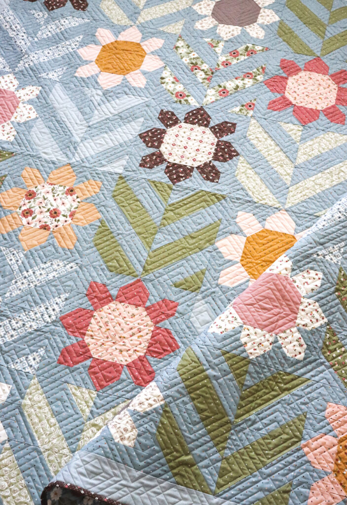 Spring Fling flower quilt PDf pattern by Lella Boutique. Make it with fat quarters, fat eighths, and half-yards. Fabric is Folktale by Lella Boutique for Moda Fabrics.