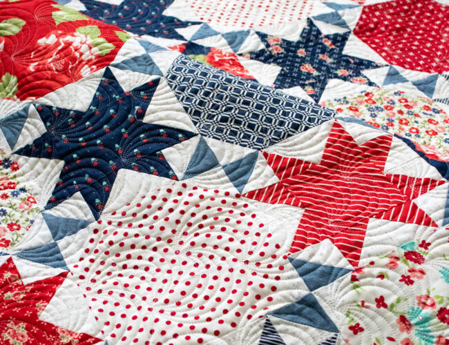 Starstruck 2 patriotic quilt in red white and blue. Make it with Layer Cakes or fat quarters. Fabric is Early Bird by Bonnie & Camille for Moda Fabrics.
