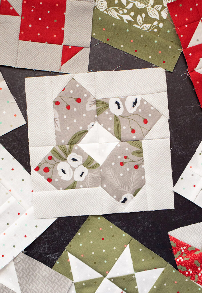 Sewcialites Quilt Along: Free Block of the Week. Block 15 is "Genuine" by Lori Holt of Bee in My Bonnet. Fabric is Christmas Morning by Lella Boutique.