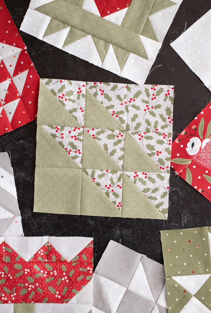 Sewcialites Quilt Along: Free Block of the Week by Fat Quarter Shop. Block 31 is "Noble" by Susan Ache. Fabric is Christmas Morning by Lella Boutique for Moda Fabrics.