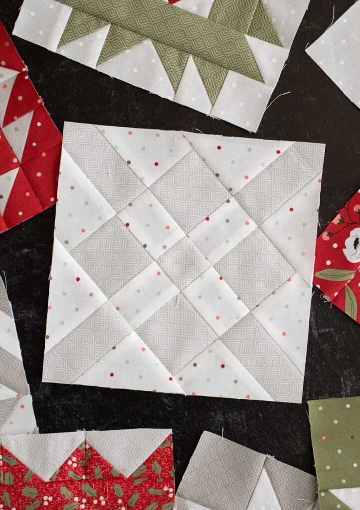 Sewcialites Quilt Along: Free Block of the Week by Fat Quarter Shop. Block 34 is "Passion" by Carrie Nelson. Fabric is Christmas Morning by Lella Boutique for Moda Fabrics.