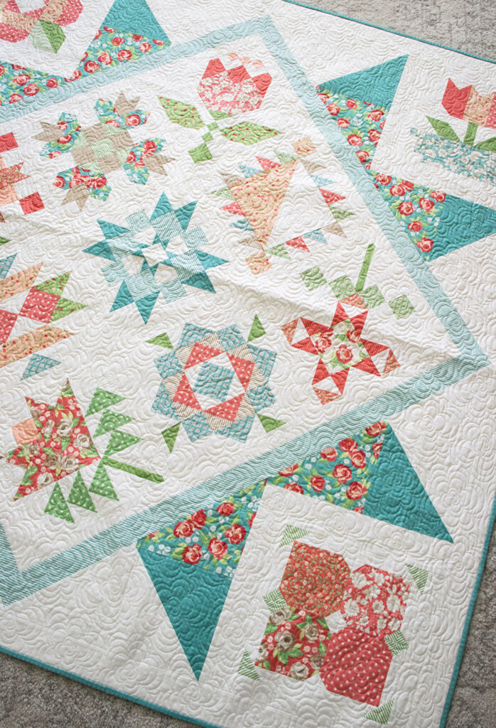 2020 Designer Mystery Quilt in Bloomington fabric by Lella Boutique for Moda Fabrics. See the finished quilt and download the block patterns here!