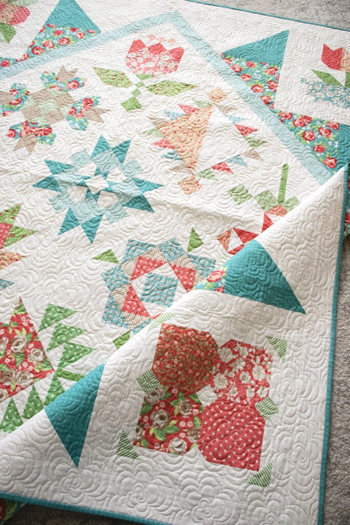 2020 Designer Mystery Quilt in Bloomington fabric by Lella Boutique for Moda Fabrics. See the finished quilt and download the block patterns here!