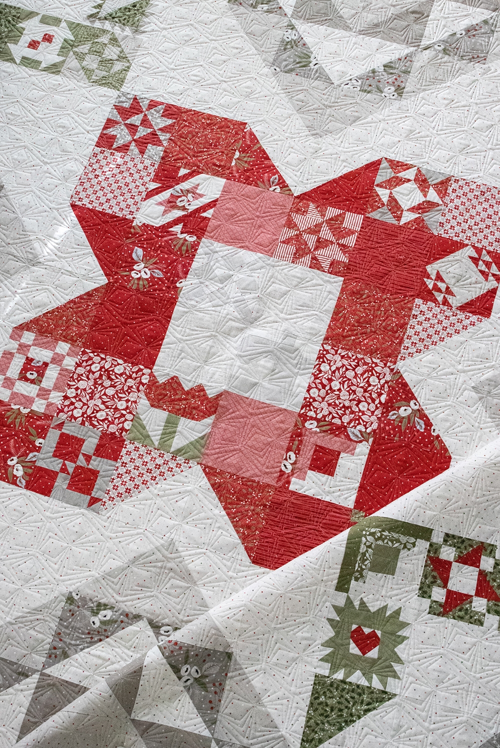 Rose in Bloom quilt in Christmas Morning fabric by Lella Boutique. Vanessa plugged in the Sewcialites sampler blocks into the Rose in Bloom quilt layout.
