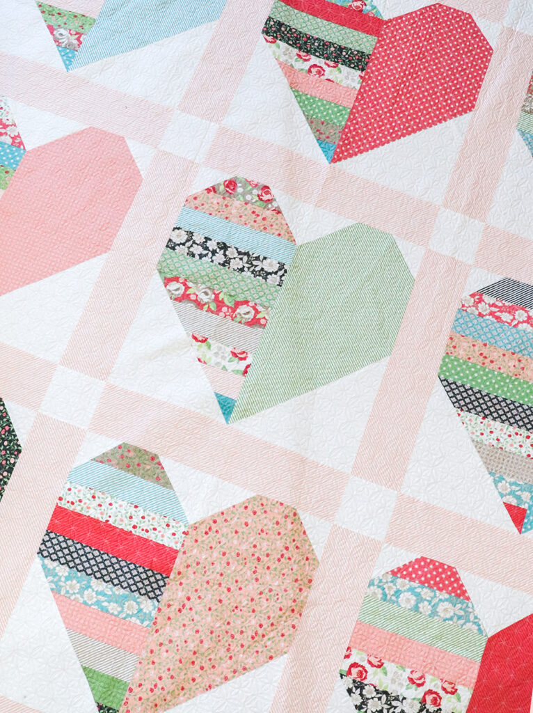 Heartthrob jelly roll heart quilt by Vanessa Goertzen of Lella Boutique. Pattern is from her book: Jelly Filled - 18 Quilts from 2-1/2" Strips. Fabric is Bloomington by Lella Boutique for Moda Fabrics.