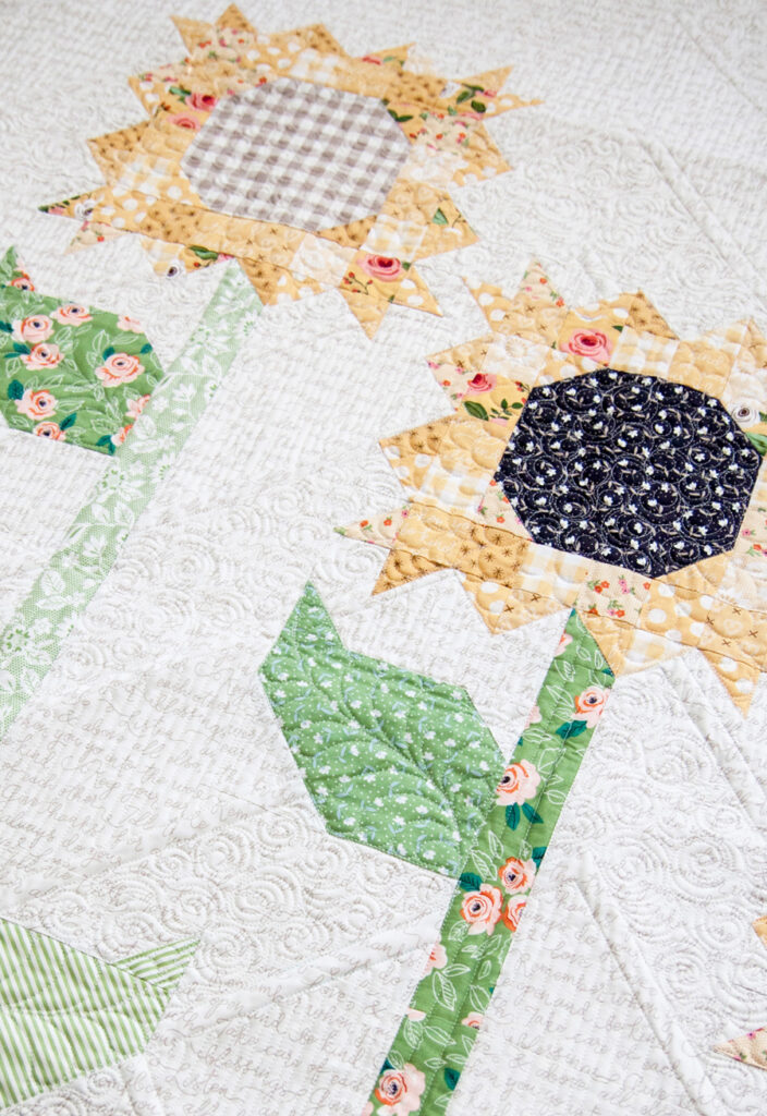 Scrappy Sunflowers quilt pattern by Lella Boutique. Fabric is Farmer's Daughter by Lella Boutique for Moda Fabrics