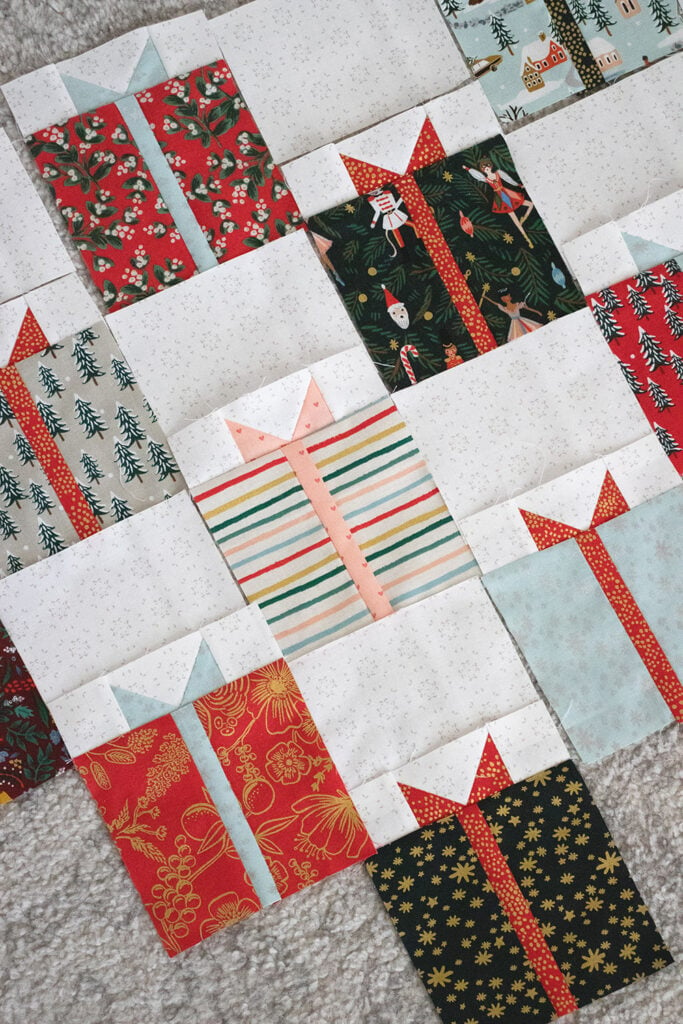 Gift Swap Christmas present quilt by Lella Boutique. Fabric is Holiday Classics by RIfle Paper Co for Cotton + Steel. Make it with charm packs, layer cakes, or fat quarters!