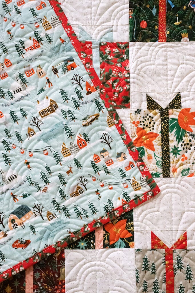 Gift Swap Christmas present quilt by Lella Boutique. Fabric is Holiday Classics by RIfle Paper Co for Cotton + Steel. Make it with charm packs, layer cakes, or fat quarters!