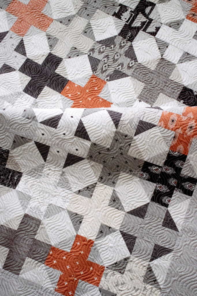 Hot Cross Buns plus sign quilt by Lella Boutique. Make it with a Jelly Roll (2.5" strips) or a Layer Cake (10" squares). Fabric is Smoke & Rust by Lella Boutique for Moda Fabrics.