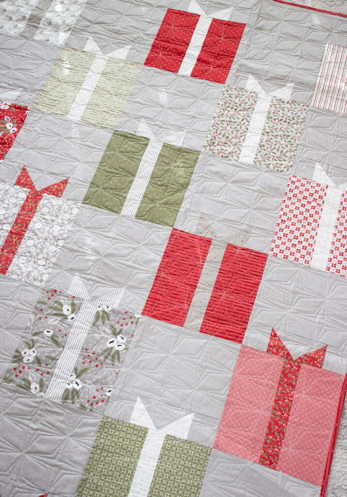 Nice List present quilt by Vanessa Goertzen of Lella Boutique. Make it with a layer cake! Fabric is Christmas Morning by Lella Boutique for Moda Fabrics.