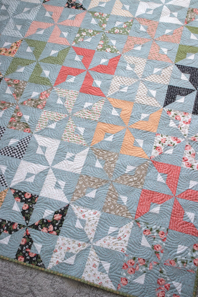 Busybody geometric quilt by Vanessa Goertzen of Lella Boutique. Make it with a Layer Cake or Jelly Roll. Fabric is Country Rose by Lella Boutique for Moda Fabrics.