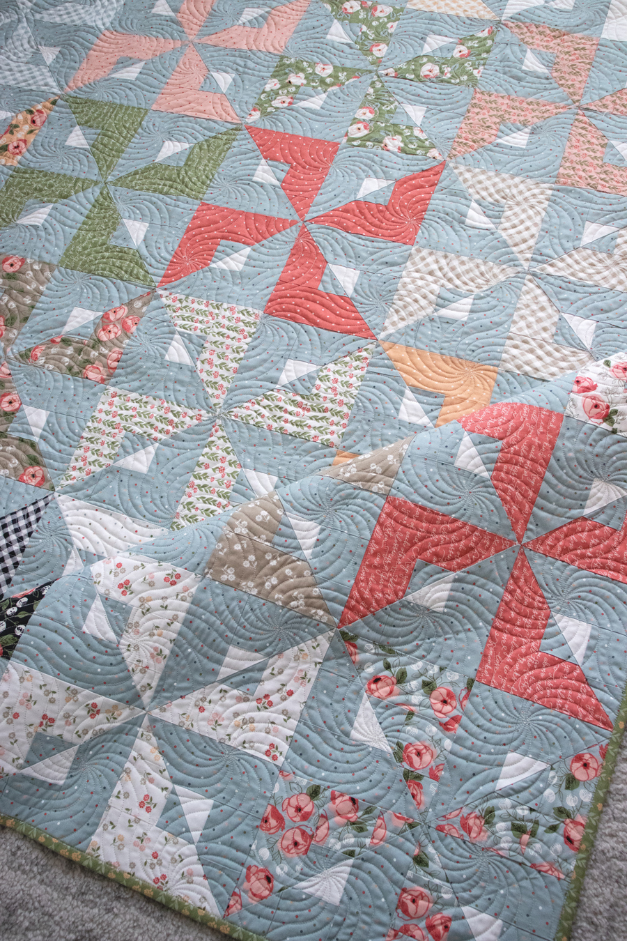 Busybody pinwheel quilt by Vanessa Goertzen of Lella Boutique. Make it with a Layer Cake or Jelly Roll. Fabric is Country Rose by Lella Boutique for Moda Fabrics.