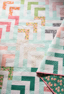 Beachcomber jelly roll log cabin quilt by Vanessa Goertzen of Lella Boutique. Fabric is Sugar Pie by Lella Boutique for Moda Fabrics.
