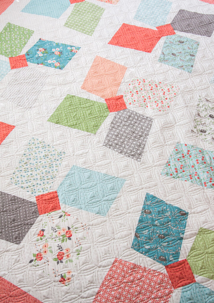 Easy Breezy layer cake pinwheel quilt by Vanessa Goertzen of Lella Boutique. Fabric is Nest by Lella Boutique for Moda Fabrics.