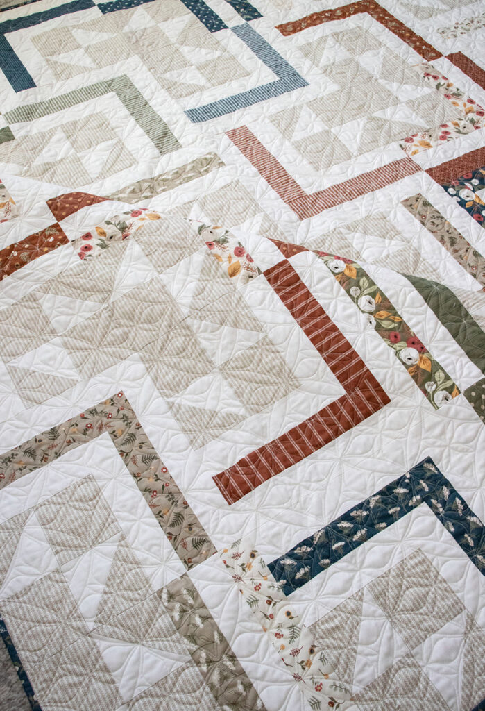 FREE Smart Cookie jelly roll quilt PDF pattern by Lella Boutique. Cool log cabin design in Flower Pot fabric. Download the pattern here.