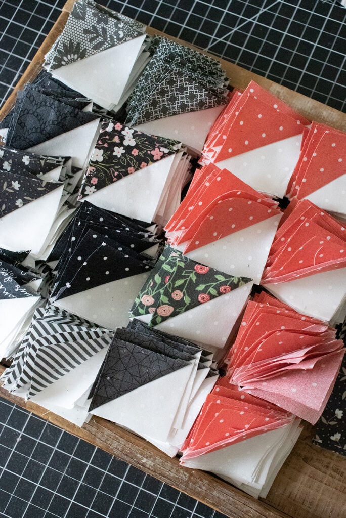 Pretty little half-square triangles in charcoal and pink Lella Boutique fabrics.