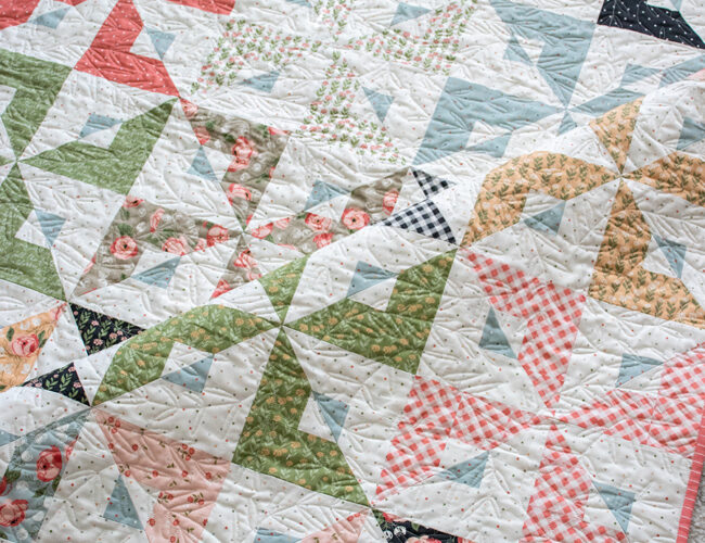 Busybody pinwheel quilt in Country Rose fabric by Lella Boutique for Moda Fabrics. Jelly Roll friendly pattern available for download here!