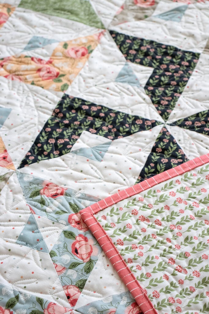 Busybody pinwheel quilt in Country Rose fabric by Lella Boutique for Moda Fabrics. Jelly Roll friendly pattern available for download here!