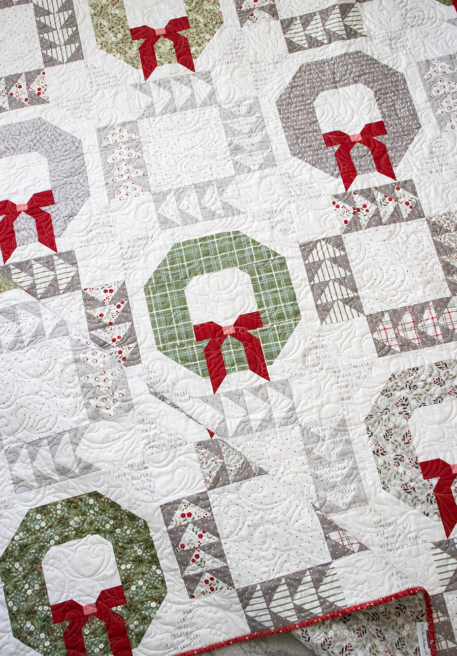 Good Tidings wreath quilt by Vanessa Goertzen of Lella Boutique. Make it with fat quarters. Fabric is Christmas Eve by Lella Boutique for Moda Fabrics (May 2023). Download the PDF pattern here!