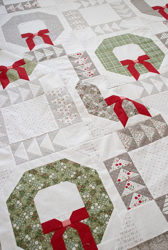 Good Tidings wreath quilt by Vanessa Goertzen of Lella Boutique. Make it with fat quarters. Fabric is Christmas Eve by Lella Boutique for Moda Fabrics (May 2023). Download the PDF pattern here!