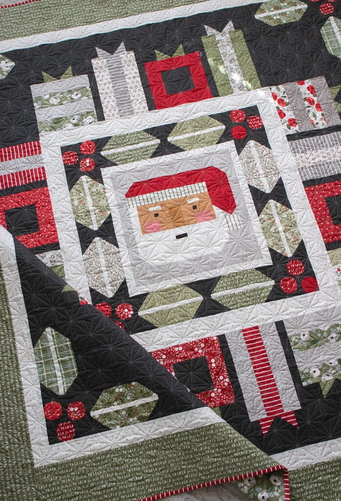 Jolly Holiday Santa medallion quilt by Vanessa Goertzen of Lella Boutique. Jelly Roll or fat eighth friendly. Fabric is Christmas Eve by Lella Boutique for Moda Fabrics.