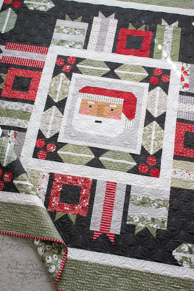 Jolly Holiday Santa medallion quilt by Vanessa Goertzen of Lella Boutique. Jelly Roll or fat eighth friendly. Fabric is Christmas Eve by Lella Boutique for Moda Fabrics.