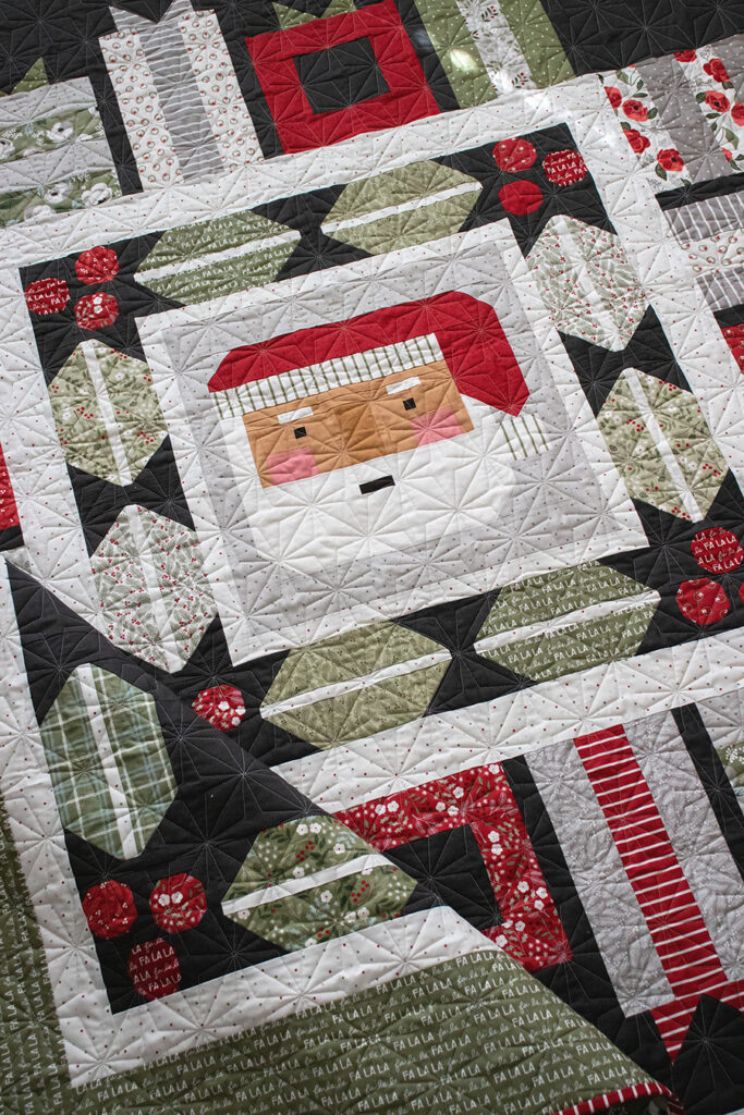 Jolly Holiday Santa medallion quilt by Vanessa Goertzen of Lella Boutique. Jelly Roll or fat eighth friendly. Fabric is Christmas Eve by Lella Boutique for Moda Fabrics.