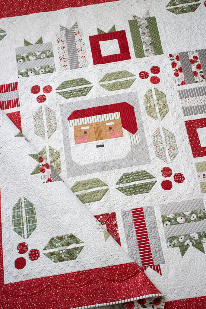 "Jolly Holiday" Christmas medallion quilt by Vanessa Goertzen of Lella Boutique. Jelly Roll friendly!! Fabric is Christmas Eve by Lella Boutique for Moda Fabrics (arriving May 2023). Cute Santa quilt block, holly and berry blocks, and a variety of gift blocks all in one!