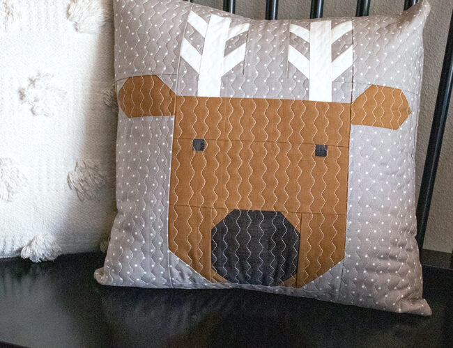 Reindeer Xing pillow in Christmas Eve fabric by Lella Boutique. Get the reindeer pillow pattern here!