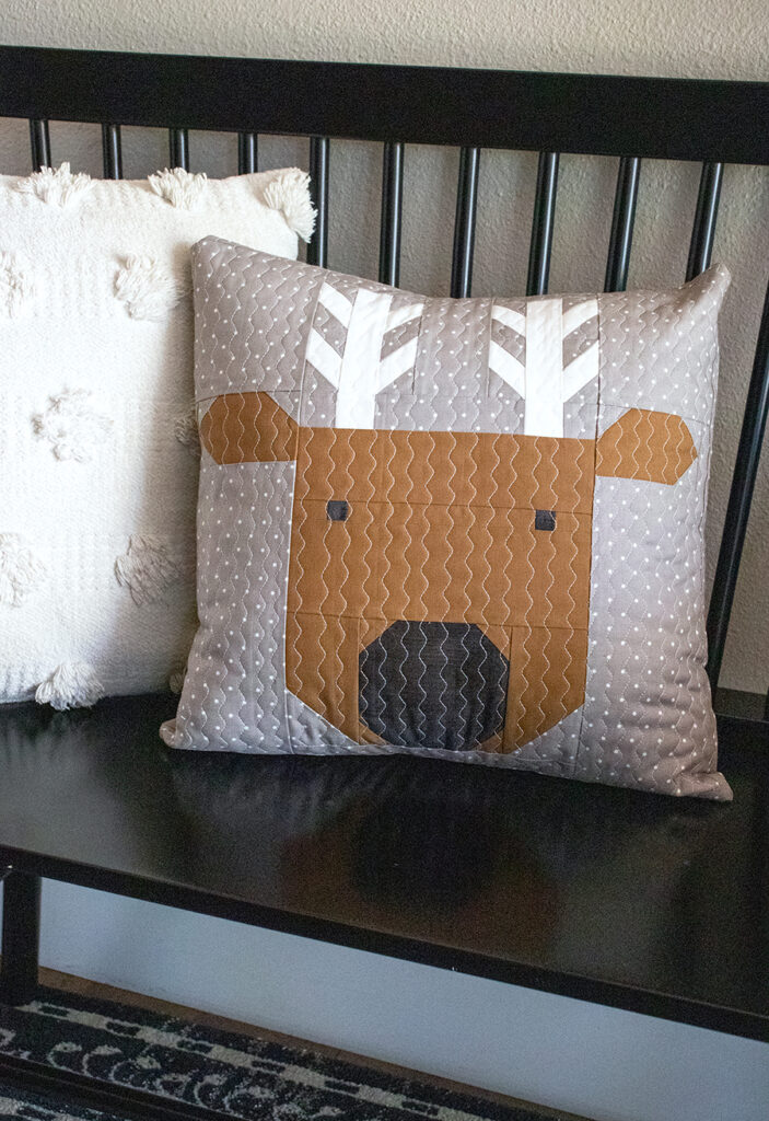 Reindeer Xing pillow in Christmas Eve fabric by Lella Boutique. Get the reindeer pillow pattern here!
