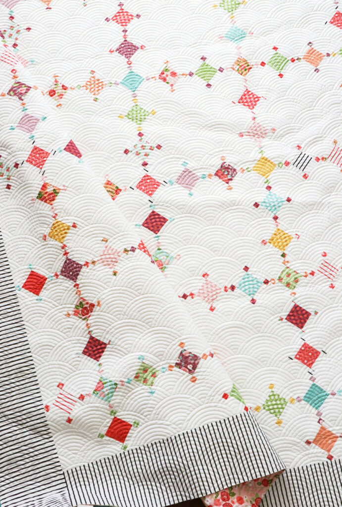 Diamond Dust quilt by Vanessa Goertzen of Lella Boutique. Make it with charm packs, mini charm packs, fat eighths, layer cakes, or scraps. Fabric is Lollipop Garden by Lella Boutique for Moda. Download the pattern here!