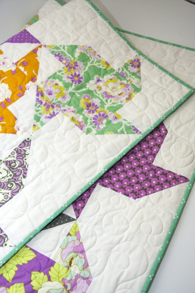 Twirl pinwheel quilt by Lella Boutique. Beginner friendly quilt using fat quarters, fat eighths, or Layer Cakes! Fabric is "Lottie Da" by Heather Bailey.