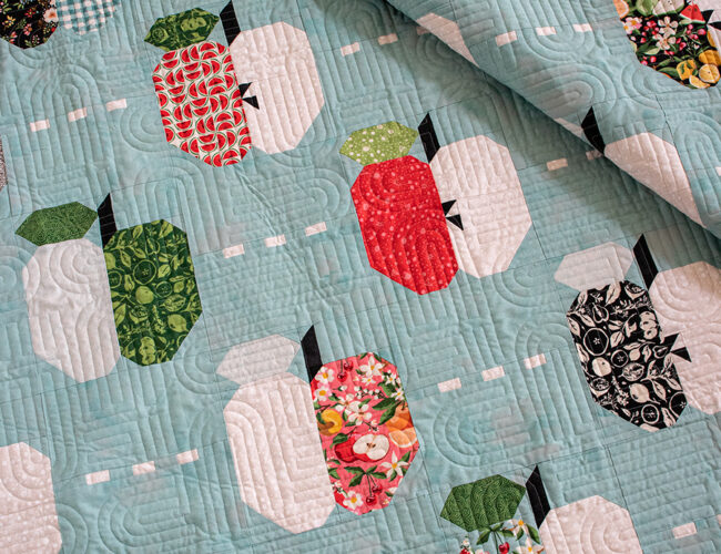 Apple Dandy layer cake quilt by Vanessa Goertzen for BasicGrey. Fabric is Fruit Loop by BasicGrey for Moda Fabrics. Cute scrappy apple quilt!