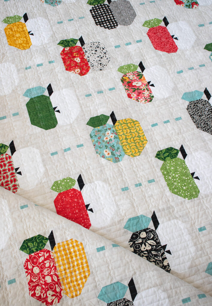 Apple Dandy layer cake quilt by Vanessa Goertzen for BasicGrey. Fabric is Fruit Loop by BasicGrey for Moda Fabrics. Cute scrappy apple quilt!