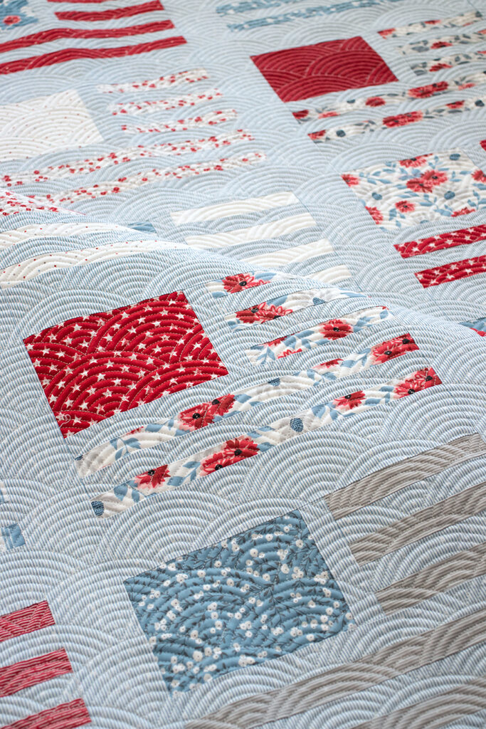 Miss Americana modern flag quilt by Vanessa Goertzen of Lella Boutique. Make it with fat quarters or a honeybun. Fabric is Old Glory by Lella Boutique for Moda Fabrics.