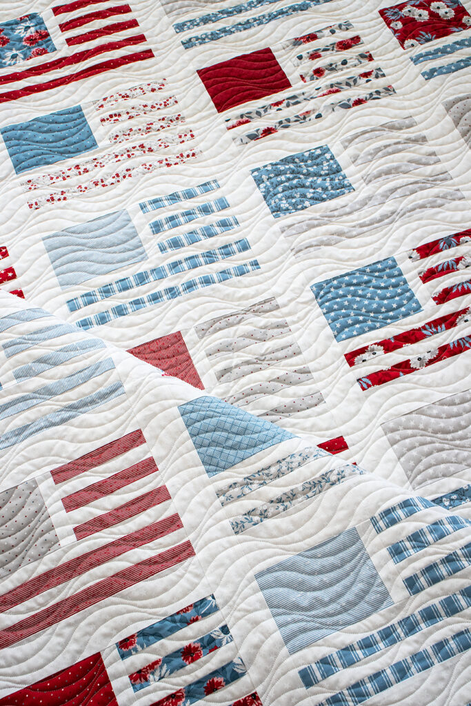 Miss Americana modern flag quilt by Vanessa Goertzen of Lella Boutique. Make it with fat quarters or a honeybun. Fabric is Old Glory by Lella Boutique for Moda Fabrics arriving Feb 2024.