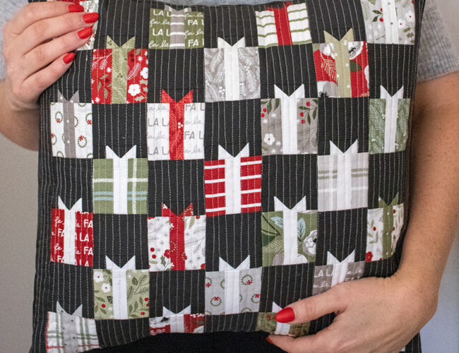 FREE Giving Season pillow pattern by Vanessa Goertzen of Lella Boutique for Moda Fabrics. Cute little Christmas present quilt made using a mini charm pack of Christmas Eve fabric. Download the free PDF here!