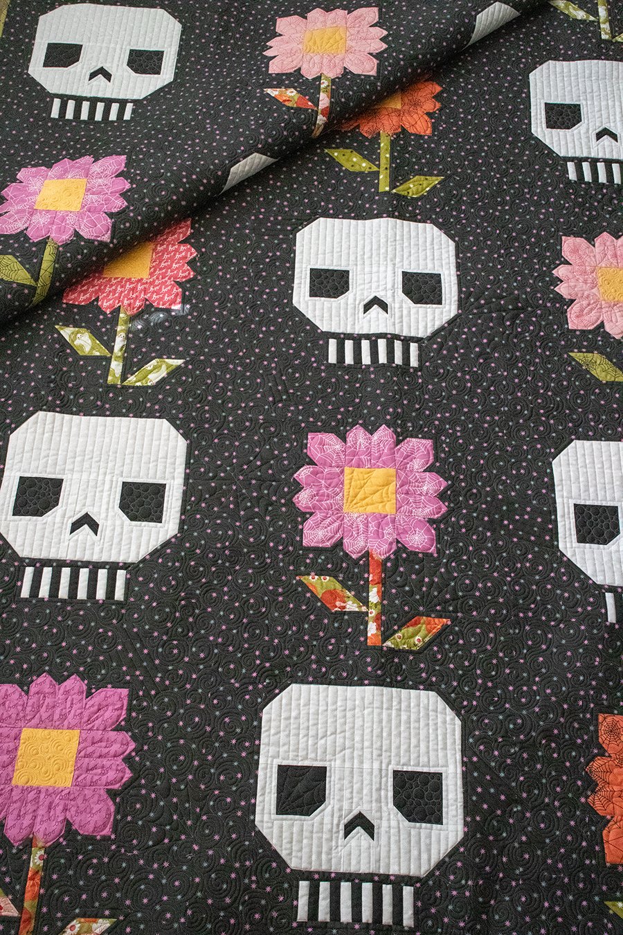 Pushing Up Daisies skull and flower Halloween quilt by Vanessa Goertzen of Lella Boutique. Would make a great Dia de los Muertos quilt in Hey Boo fabric by Lella Boutique for Moda Fabrics (arriving to shops April 2024). Download the PDF here!