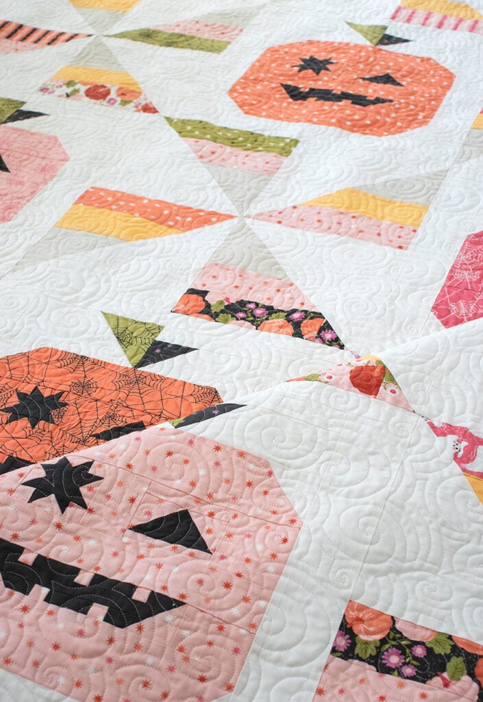 Tricks & Treats pumpkin & candy corn quilt by Lella Boutique. Cute little winking Jack-o-lantern quilt blocks in Hey Boo fabric by Lella Boutique for Moda Fabrics coming April 2024. Download the PDF here!