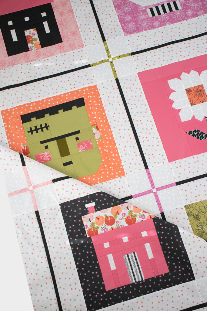 the Monster Mash sampler quilt by Lella Boutique. Cute Halloween block of the month with haunted house, skull, Frankenstein, pumpkin, ghost, and haunted daisy patchwork blocks. Fabric is Hey Boo by Lella Boutique for Moda Fabrics (April 2024). Quilt Along begins in May!