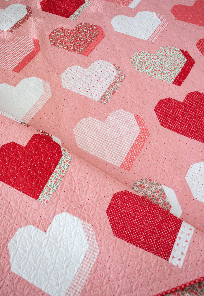 "Beloved" 3D heart quilt by Lella Boutique. Fat quarter friendly valentines quilt in Love Blooms fabric by Lella Boutique for Moda Fabrics (Nov 2024). Download the PDF here!