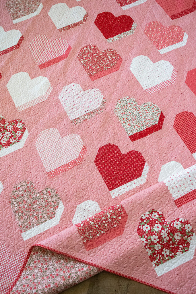 "Beloved" 3D heart quilt by Lella Boutique. Fat quarter friendly valentines quilt in Love Blooms fabric by Lella Boutique for Moda Fabrics (Nov 2024). Download the PDF here!