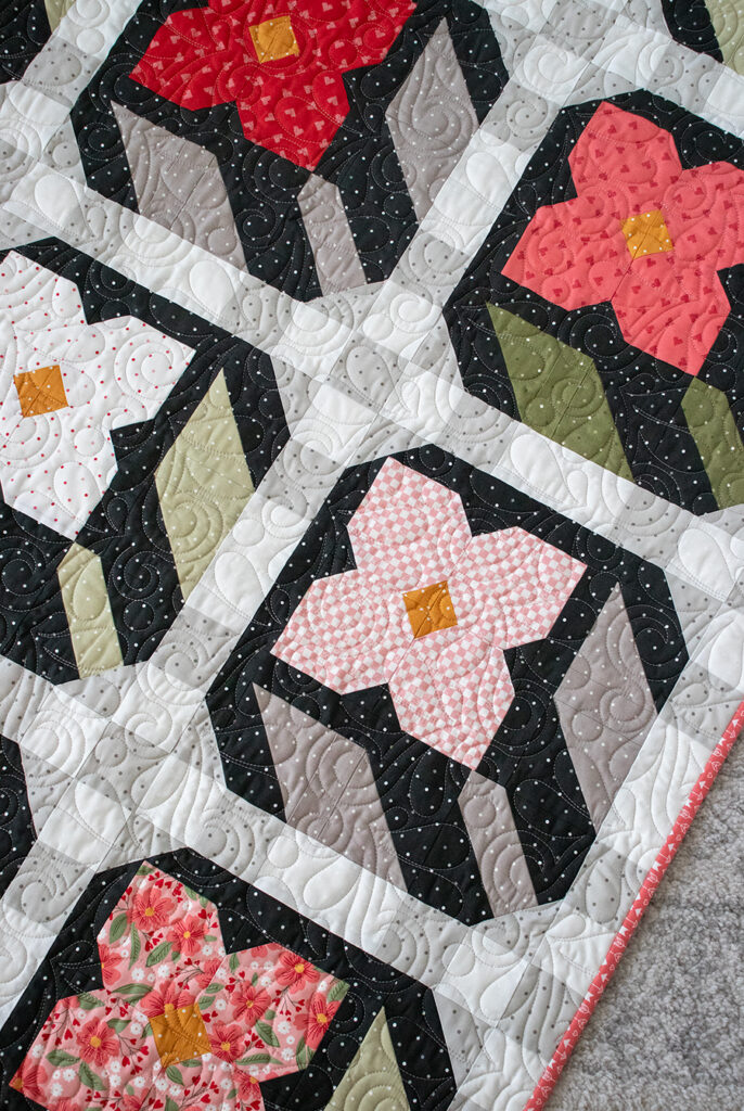 Flower Press layer cake quilt in Love Blooms fabric by Lella Boutique for Moda Fabrics. Cute flower patchwork block!